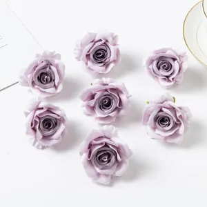 Close-up detail shot of artificial purple rose fabric flower heads for DIY crafts and decor.