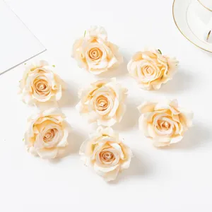 Artificial silk rose heads detail shot, champagne colored floral decorations for DIY crafts.