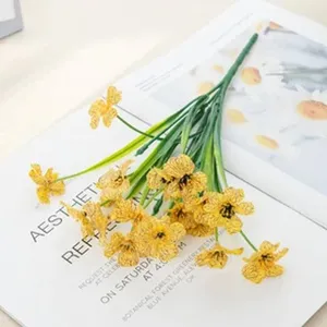 Detailed view of artificial yellow daisy flower bouquet, decorative fake floral arrangement.