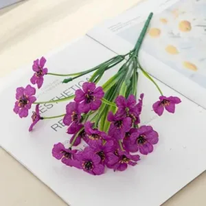 Artificial purple daisy flower detail, plastic floral arrangement for home decor and photography.
