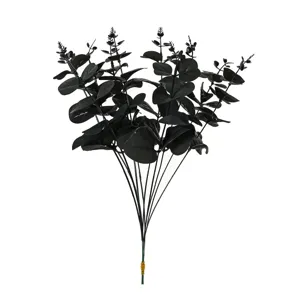 Close-up detail of black artificial eucalyptus leaves branch, Halloween floral arrangement supply