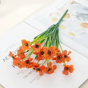 Detailed shot of artificial orange flower bouquet, plastic silk daisy home decor ornament.