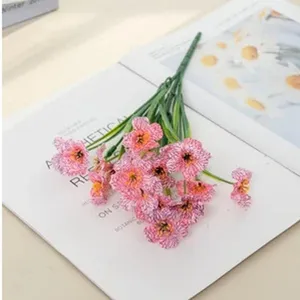 Detailed closeup of artificial pink patterned daisy flowers used as home decor and photo props.