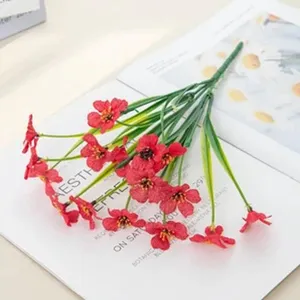 Artificial red flower bouquet for home decoration, plastic and silk plants detail view.