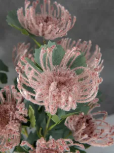 Detailed close-up of artificial flocked pink spider chrysanthemum flowers for home decor.
