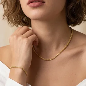 Detail shot of an elegant 925 sterling silver gold-plated Franco chain jewelry set on a model.