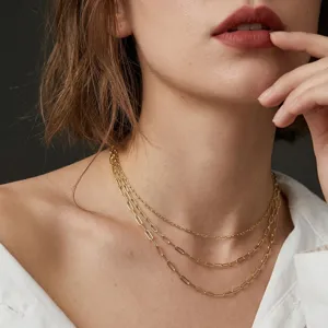 Detailed macro view of three layered gold paperclip and cross link chains on a model