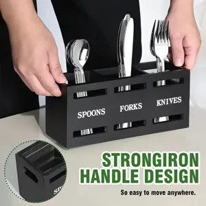 Close up of black wooden cutlery organizer with divided compartments for spoons forks knives.