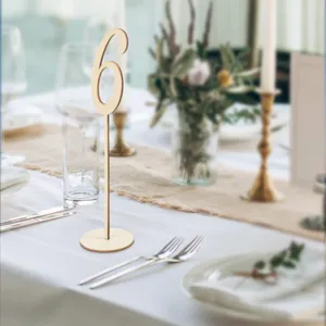 Wooden table number sign detail view showcasing number 6 in an elegant wedding table setting.