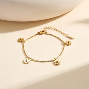 Detailed view of the gold-plated stainless steel bracelet with delicate flower charms