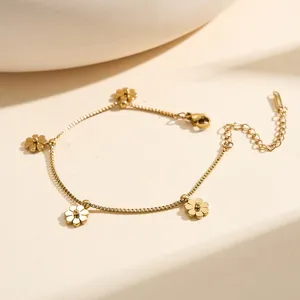 Detailed view of the gold-plated daisy charms on a stainless steel box chain