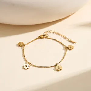 Detailed view of gold stainless steel bracelet with daisy flower charms