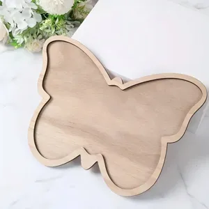 Detailed view of creative butterfly shaped wooden tray for party snacks, fruit and dessert display.