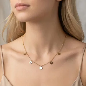 Close-up of elegant gold stainless steel necklace with delicate daisy flower charms