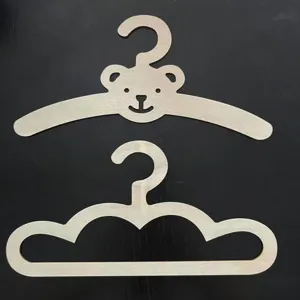 Wooden children clothes hangers with cute bear and cloud shapes, creative baby room decor.