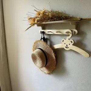 Wooden bear children wall shelf detail, creative kids room hanging rack with cute animal decor.