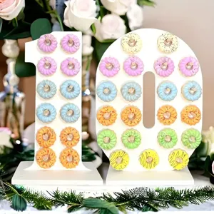 Wooden number 10 donut wall stand detail showing colorful sweet treats on pegs for party setup.