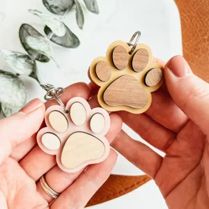 Wooden paw print keychain detail, double color cute key ring accessory for bags and keys.