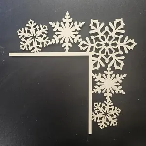 Wooden snowflake door corner detail view, laser cut Christmas holiday decoration.