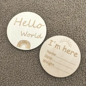 Wooden baby milestone cards detail shot, featuring Hello World and newborn tracking design.