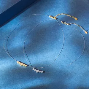 Detail of 925 silver heart and zirconia necklaces with transparent fishing line