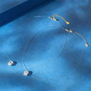 Macro view of minimalist invisible fishline necklace with sparkling emerald-cut CZ pendant