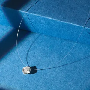 Detailed macro view of a sparkling round zircon pendant on an invisible fishing line chain