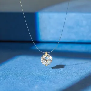 Macro detail showing the brilliant round zircon pendant on an invisible fishing line chain.