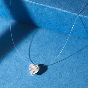 Detailed macro view of sparkling heart-shaped zircon pendant on fish line choker