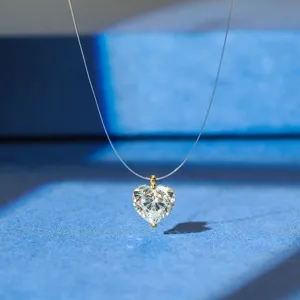 Detail shot of a sparkling heart-shaped zircon pendant on an invisible choker line.