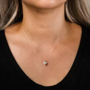 Close-up of a delicate zircon flower pendant on a transparent invisible choker necklace