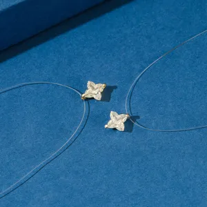 Close-up of S925 silver star pendant necklaces with sparkling zircons on blue background