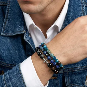 Close-up of men's handmade natural stone beaded energy bracelets with a silver cross charm