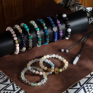 Detailed view of handmade natural stone energy beaded bracelets and pendant on display