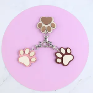 Wooden paw print keychain detail, creative multi-color wood pendant and metal clasp accessory.