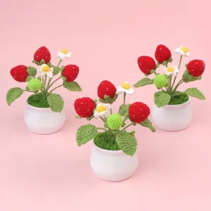 Exquisite detail of three handmade crochet strawberry potted plants for cute home decoration