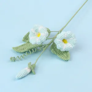 Macro detail of handmade crochet morning glory flower in soft blue yarn