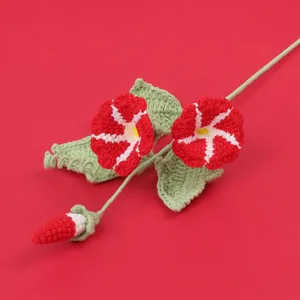 Handmade crochet red morning glory flower detail showing knitted wool texture