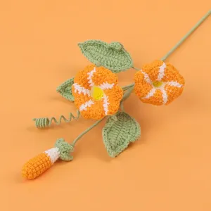 Detailed view of handmade crocheted morning glory with vibrant orange yarn texture