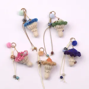 Group of colorful handmade crochet mushroom keychains with pom-poms and wooden beads