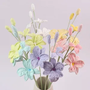 Nahaufnahme von farbenfrohen handgehäkelten Orchideen aus Wolle in einer Vase