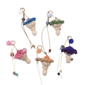 Adorable set of five handmade crochet mushroom keychains with colorful yarn and pom-poms