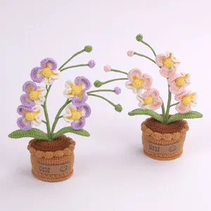 Zwei handgehäkelte Orchideen-Topfpflanzen in Lila und Rosa für die Tischdekoration