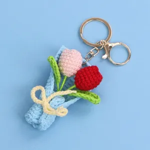Detailed macro view of a hand-crocheted mini tulip bouquet keychain in pink and red colors