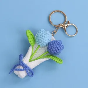 Detailed view of a handmade crocheted blue tulip bouquet keychain with golden clasp.