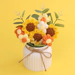 Detailed macro view of a handmade crochet sunflower and puff flower bouquet in a white vase