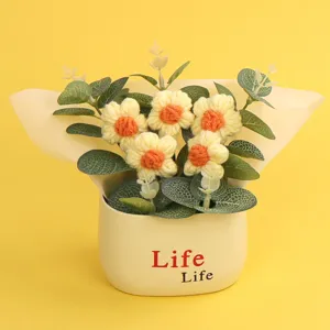 Handmade yellow crochet puff flower arrangement in cream pot on bright yellow background