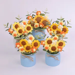 Detailed view of handmade crochet sunflower potted plants in blue ribbed ceramic vases