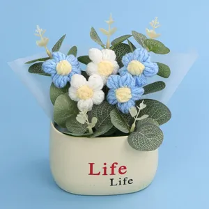 Macro detail of hand-woven crochet puffer flowers in a minimalist cream colored pot