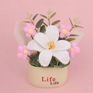 Detailed close-up view of handmade crochet flower bouquet in cream decorative pot